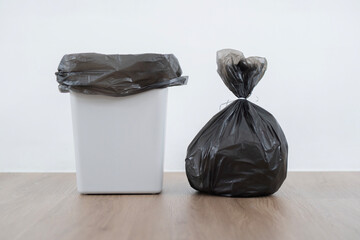 Shot of Bag with garbage and rubbish bin put on floor in kitchen. - obrazy, fototapety, plakaty