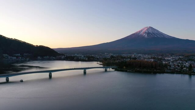 Aerial view 4k video by drone of Mount Fuji and bridge at Kawaguchi lake, Japan on morning. sunrise.