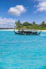 Perfect tropical island paradise beach and boat. Luxury island landscape in Maldives. Sail boat blue sea water horizon reef water villas. Tropical beach amazing aerial seascape view from drone