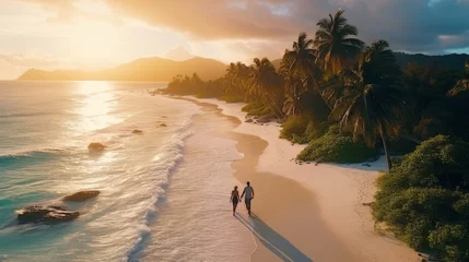 Photo sur Plexiglas Anse Source D'Agent, île de La Digue, Seychelles Couple man and woman walking on the beach of tropical island, at a luxury sunset.