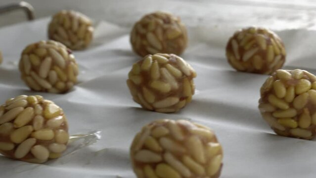 Preparation of panellets of raw pine nuts prepared for baking. Typical snack eaten on the feast of All Saints in Catalonia. 