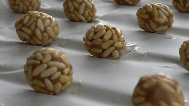 Preparation of panellets of raw pine nuts prepared for baking. Typical snack eaten on the feast of All Saints in Catalonia. 
