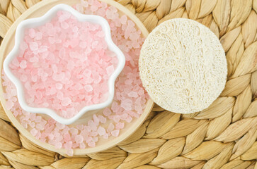 Small porcelain bowl with pink himalayan crystal bath salt (foot soak). Homemade spa and beauty recipe.