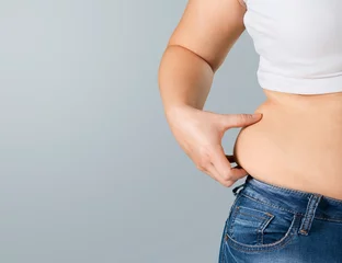 Gardinen Women body with fat belly. diet concept © BillionPhotos.com