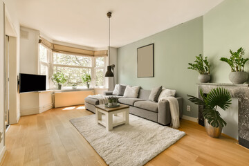 a living room with light green walls and hardwood flooring the room is well lit, but there is no furniture