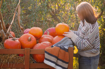 young woman on pumpkink autumn farm