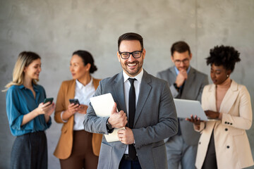 Portrait of multiethnic group of diverse corporate colleagues standing in a row at modern office