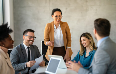 Successful business professionals presenting analytical report, working together in corporate office