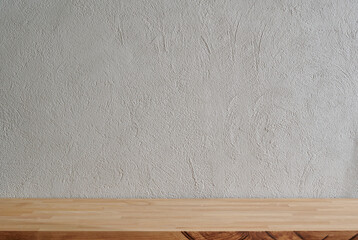 Grey stone wall background and wooden table close up, empty.