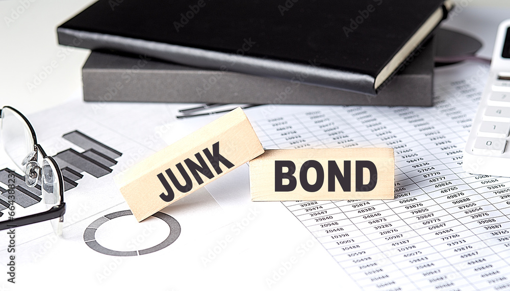 Poster junk bond - text on a wooden block with chart and notebook