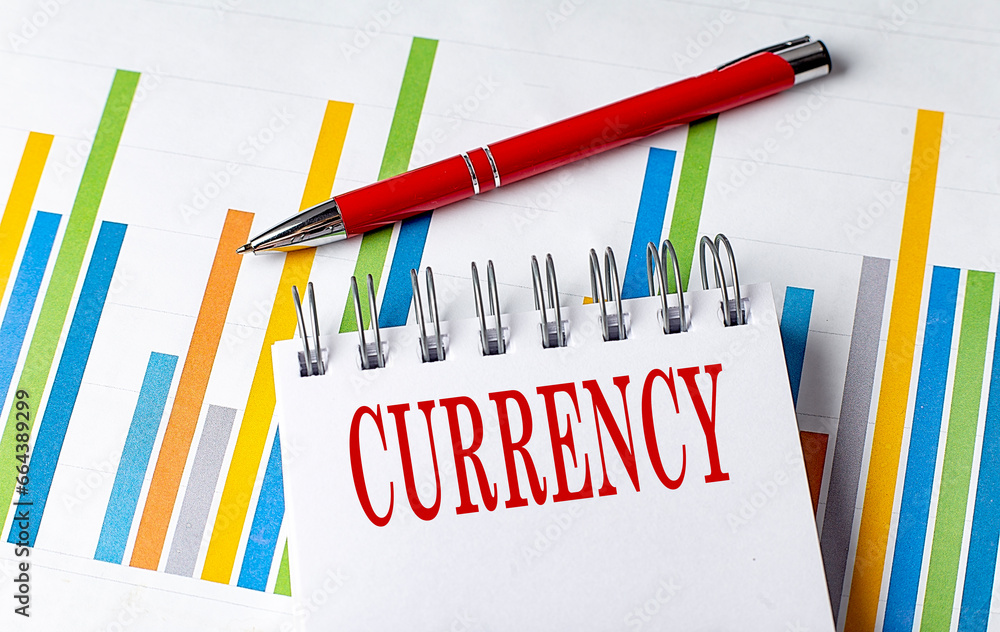 Poster currency text on a notebook with chart and pen business concept