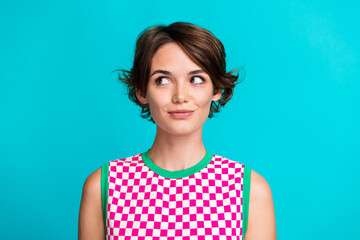 Photo of adorable lovely girl wear trendy plaid clothes looking banner blank space isolated on cyan color background