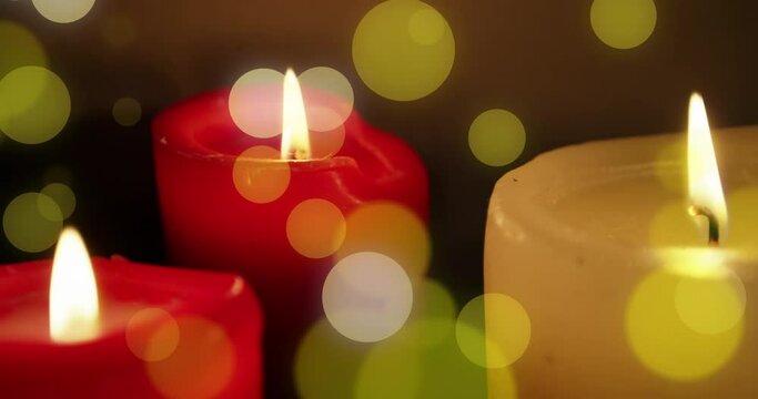 Animation of light spots over candles at christmas