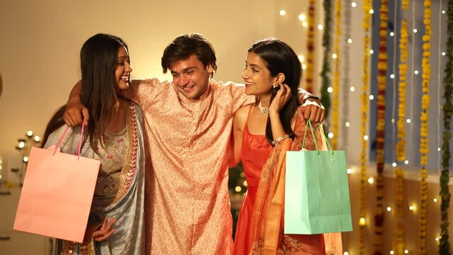 Indian Brother in traditional wear giving a gift to his cute smiling sister on Diwali. Cheerful siblings hugging each other on an auspicious occasion - a Hindu festival, celebration time.
