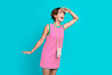 Photo of young funny lady brown hair pink dress hand forehead phone case hang neck interested...