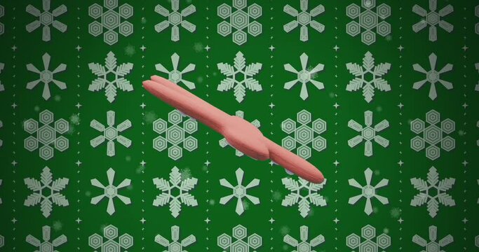 Animation of ginger bread cookie over snow pattern on green background