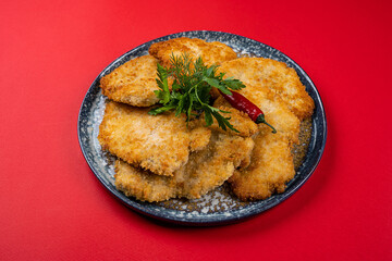 Chicken Cutlets in Batter on a Round Plate with a Red Design