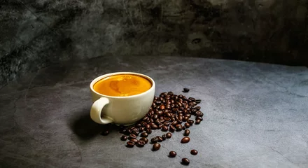 Papier Peint photo Café A cup coffee of espresso with coffee golden crema and coffee beans on a grey background.