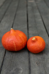 Orange halloween pumpkins on the wooden background, holiday decoration, vertical