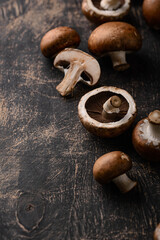 Raw champignon mushrooms on black background