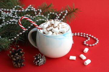 Christmas background. There is a cup of cocoa with marshmallows and Christmas decorations on a wooden table.