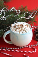 Christmas background. There is a cup of cocoa with marshmallows and Christmas decorations on a wooden table.