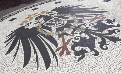Shield of mosaic near city hall at Market ofCity of Wiesbaden Germany Hesse. Bird. Eagle.