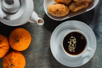 Morning breakfast - tea and light snack on a background dark
