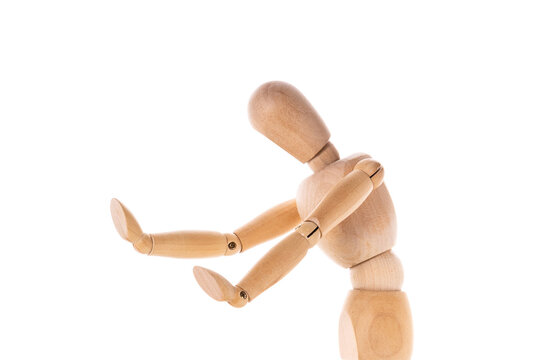 A wooden mannequin is depicted holding a tennis racquet. This image can be used to represent concepts such as sports, athletics, training, fitness, or fashion.