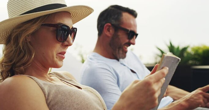 Love, relax and a couple reading books in the garden while on holiday or vacation together in summer. Smile, home or backyard with a mature man and woman on a break or getaway for their anniversary