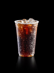 Cola soda on disposable plastic cup. Studio Shoot isolated on black background.