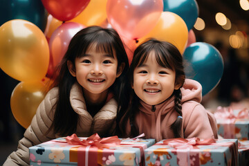 Two asian kids with balloons and presents