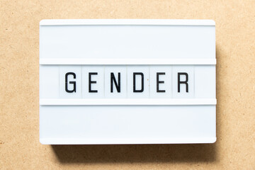 Lightbox with word gender on wood background