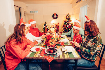 Group of happy family smiling happy celebrating christmas toasting with wine. Family member enjoy...