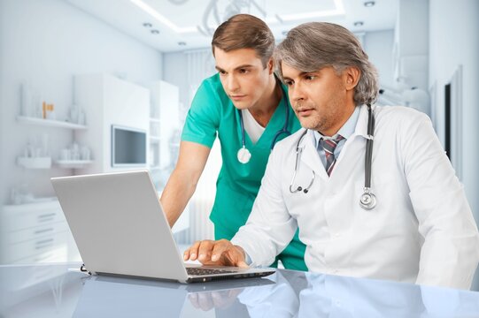 Team of doctors work with laptop in modern hospital, AI generated image