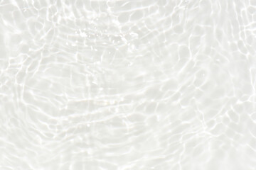 Fototapeta premium Defocus blurred transparent white colored clear calm water surface texture with splashes reflection. Trendy abstract nature background. Water waves in sunlight with copy space. Blue watercolor shine.