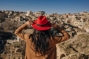 girl in a red hat in cappadocia - obrazy, fototapety, plakaty