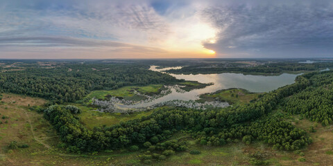 Aerial view sunset over the forest and lake
