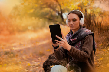 Tablet, backpack and woman traveling in nature in the forest in search of adventure, weekend trip...