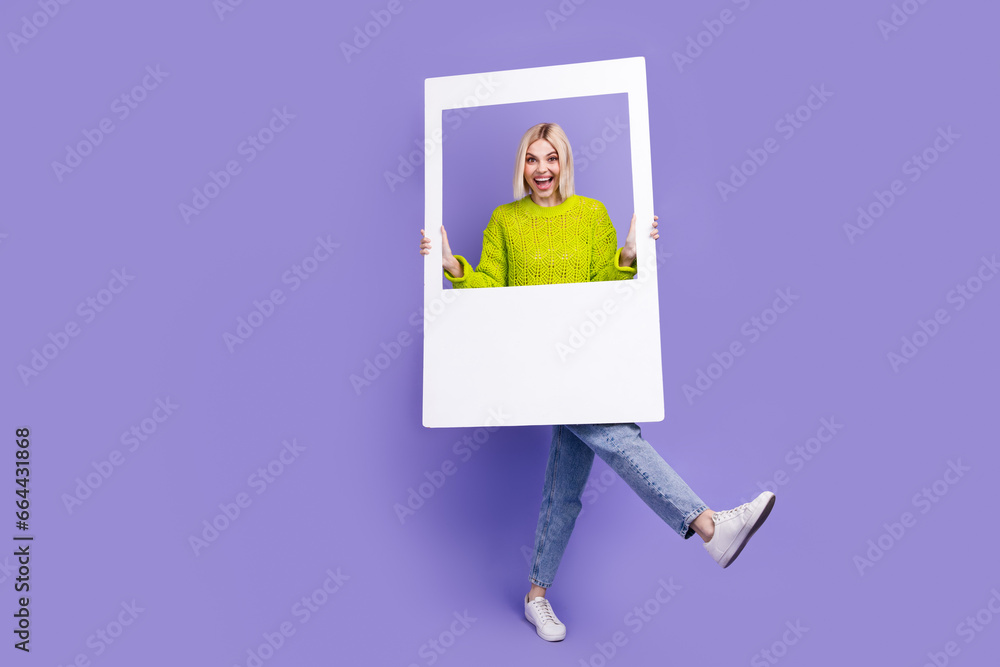 Sticker Full length photo of cute carefree lady wear green pullover holding paper frame isolated purple color background