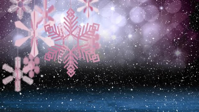 Animation of christmas decorations and snow falling on dark background