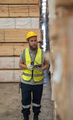 Warehouse staff verify wooded pallets items using handheld device, ensuring precise shipment.