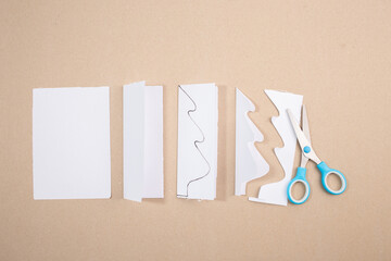 a pair of scissors sitting on top of a red piece of paper, pine tree card template, instruction, 