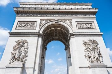 Fototapeta na wymiar Arc de Triomphe, one of the most famous monuments in Paris, massive triumphal arch, located near Champs-Elysees in Paris. Close up, selective focus