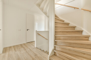 an empty room with wood flooring and staircase leading up to the second floor in a house or condo apartment