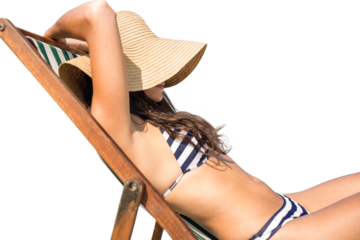 Digital png photo of caucasian woman in bikini lying in sun hat on sun bed on transparent background
