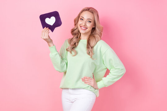 Photo portrait of gorgeous nice influencer blogging girl holding purple heart symbol subscribe instagram isolated on pink color background