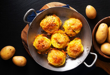 Food concept Homemade Gratin potatoes stack on black background with copy space