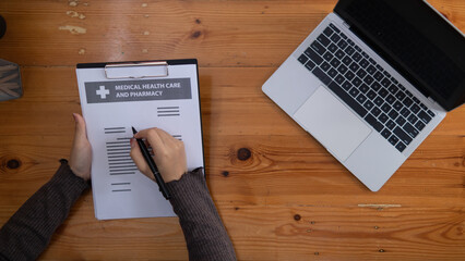 female doctor is reviewing documents to review and diagnose illness and female doctor has...