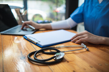 female doctor is reviewing documents to review and diagnose illness and female doctor has...